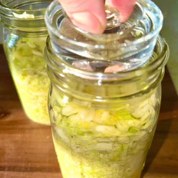 Place fermenting weight on top of homemade sauerkraut 