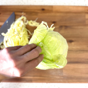 Remove outer leaves from cabbage head